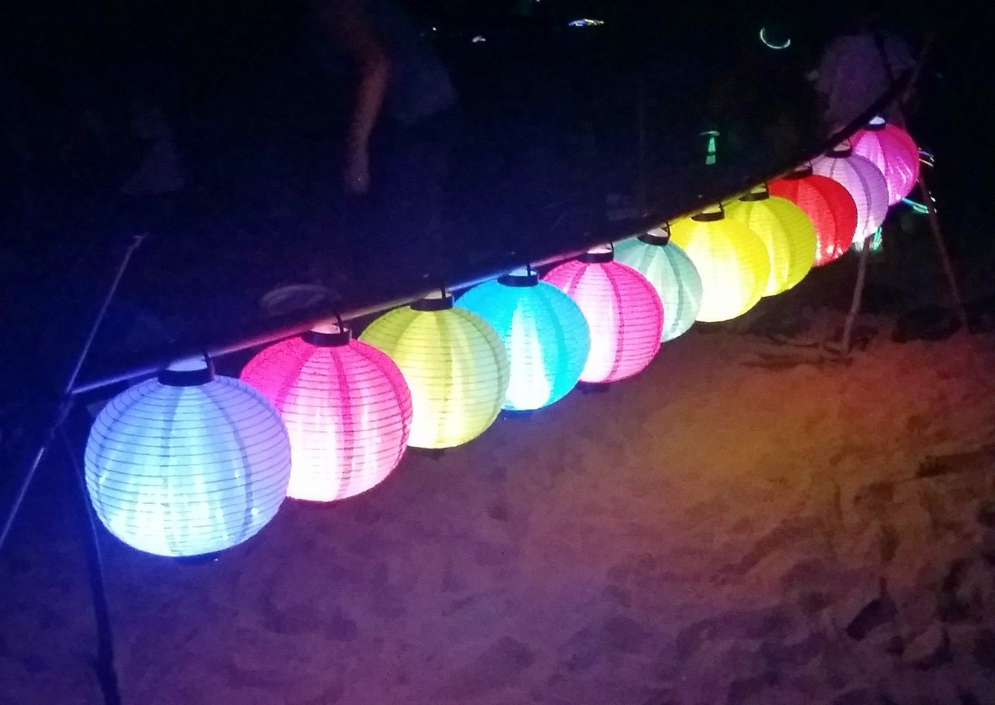 glowing paper lanterns on a beach in Hong Kong