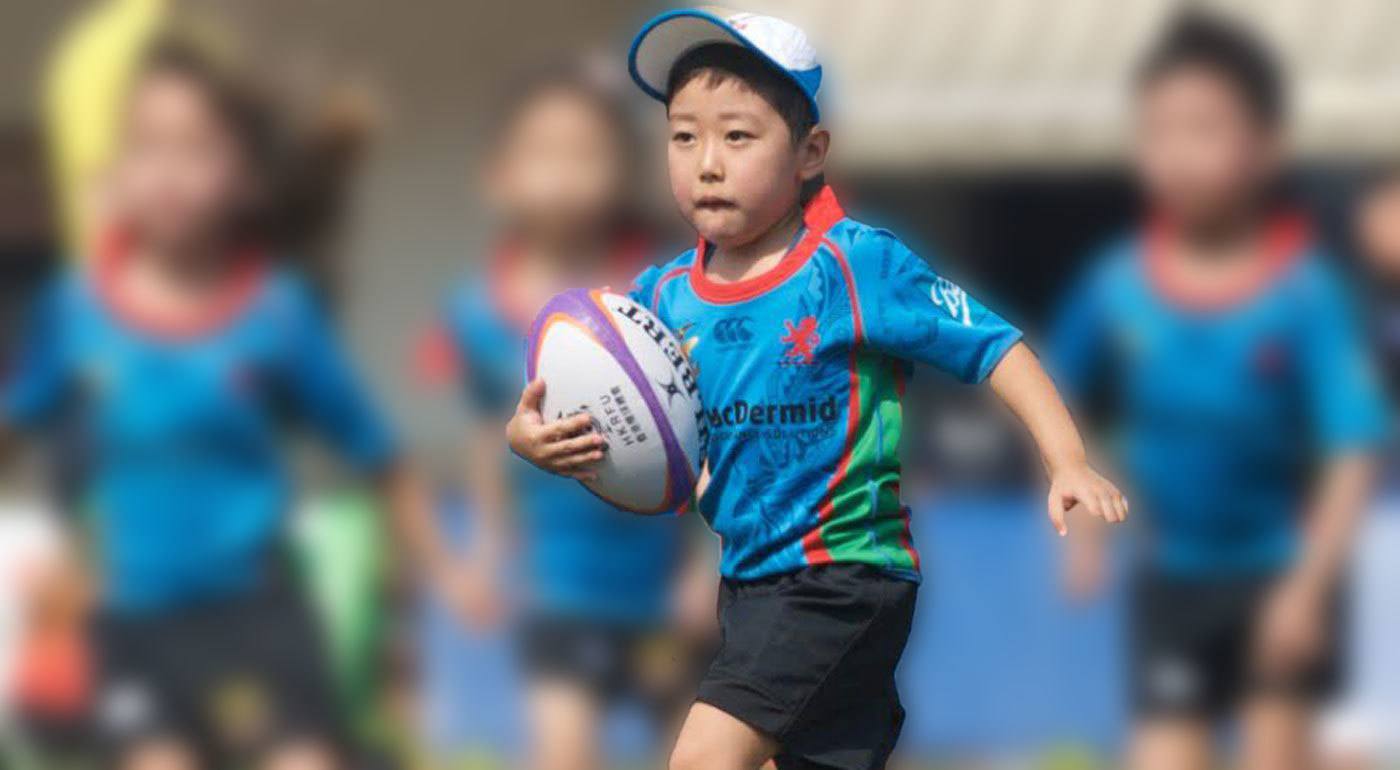 boy playing rugby at American School Hong Kong