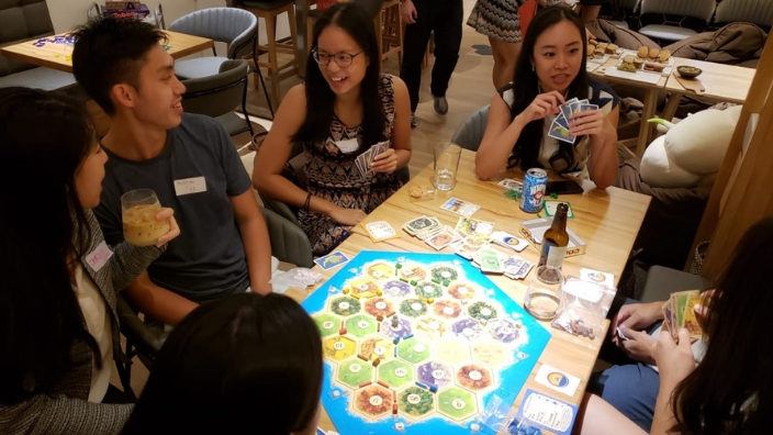 Wheat and wood friends playing board game settlers of Catan