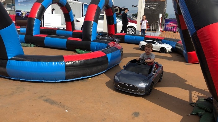 little kid driving a tesla