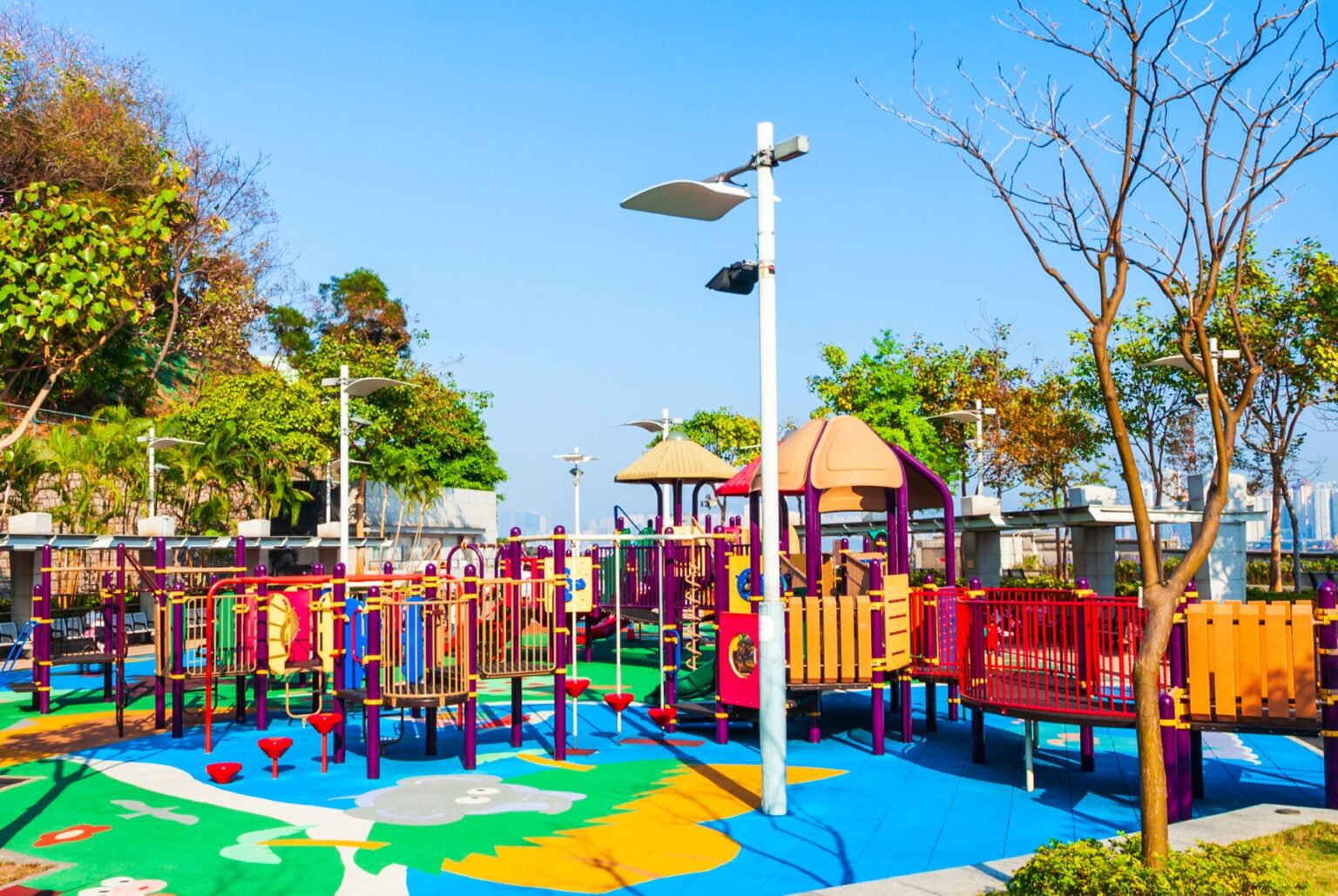 an outdoor playground in hong kong with play equipment like slide