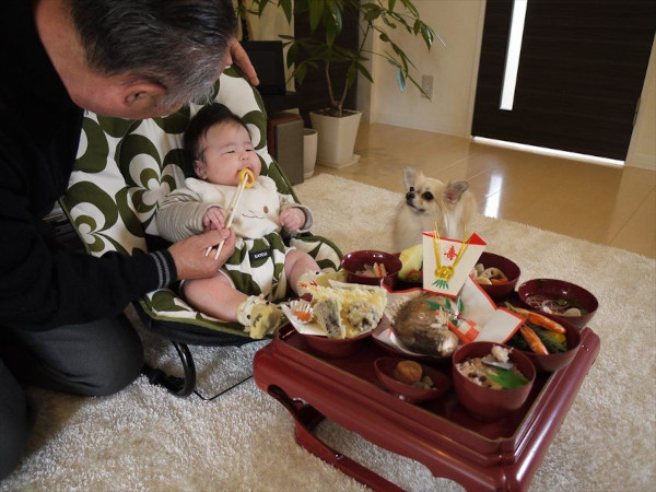 baby being fed by grandpa okuizome