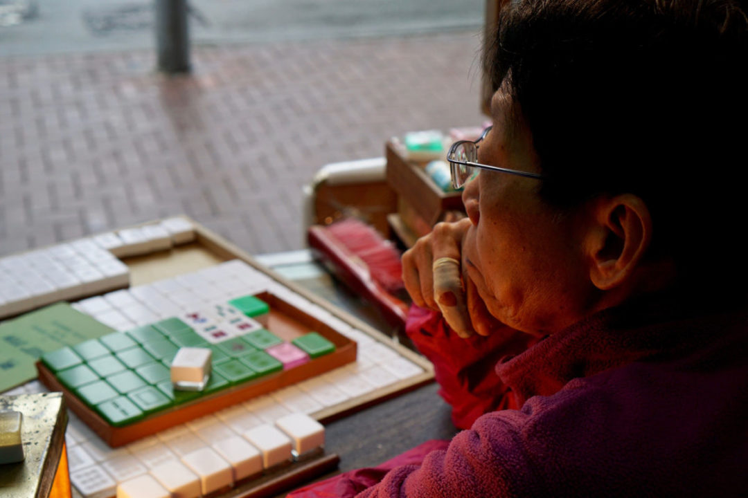 chinese woman sitting with her handmade mahjong set