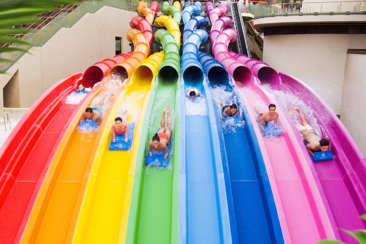 park visitors on rainbow rush slide at water world