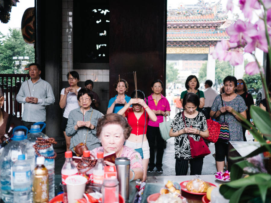 women praying at taiwan temple during ghost month