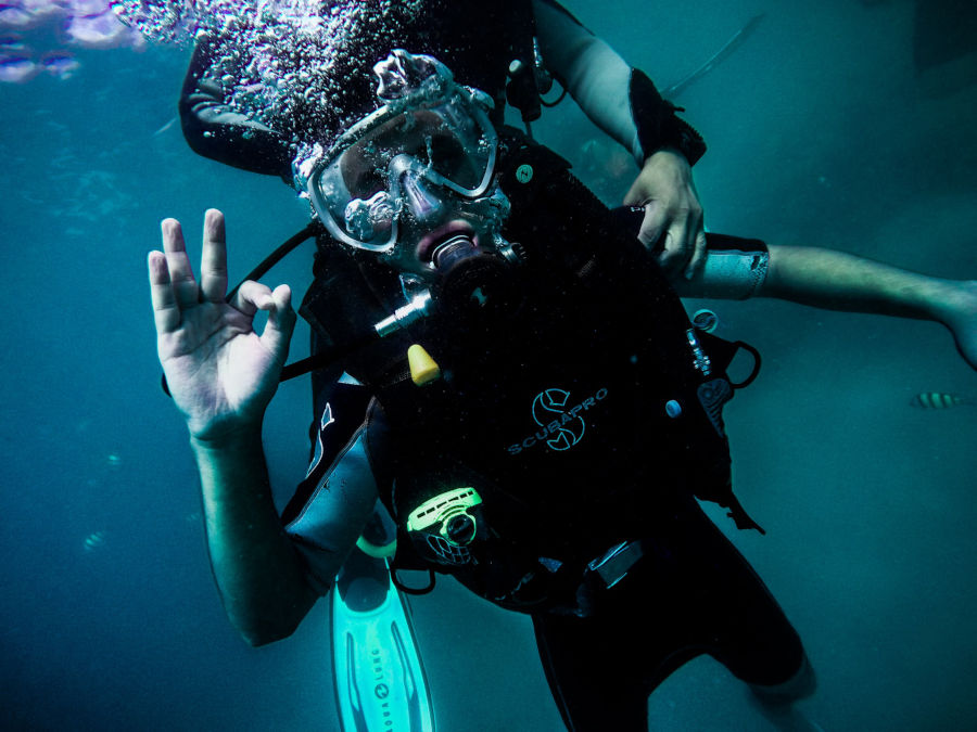 scuba diving student giving ok hand signal