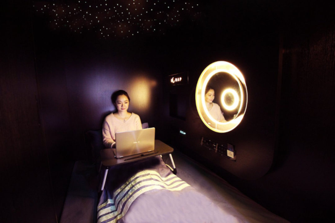 guest relaxes in pod at the nap tsim sha tsui capsule hotel