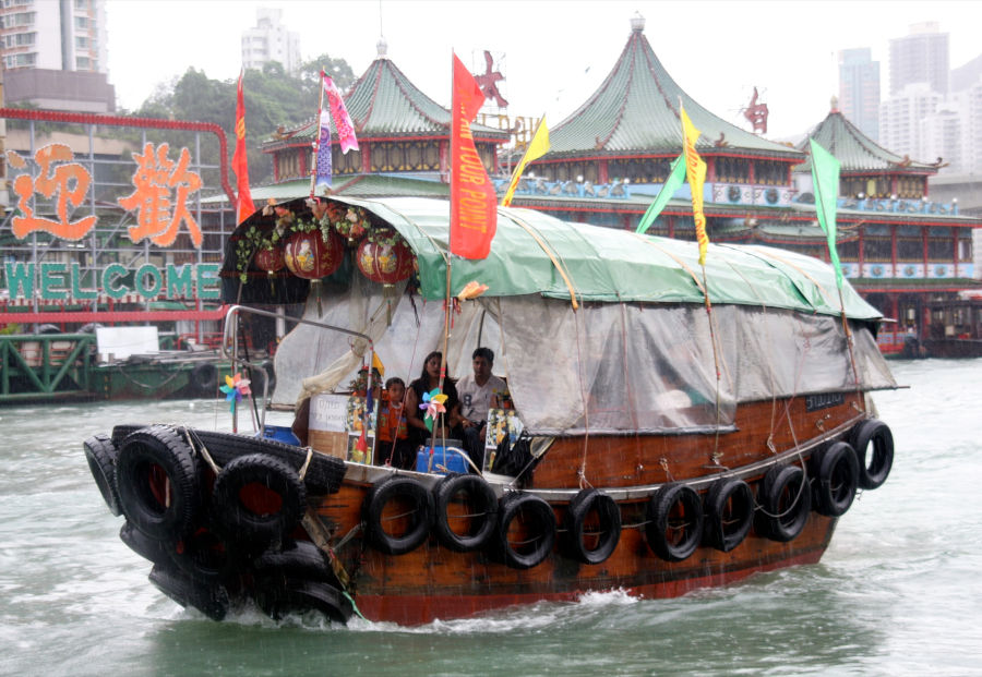 tourists aboard hired sampan in hong kong