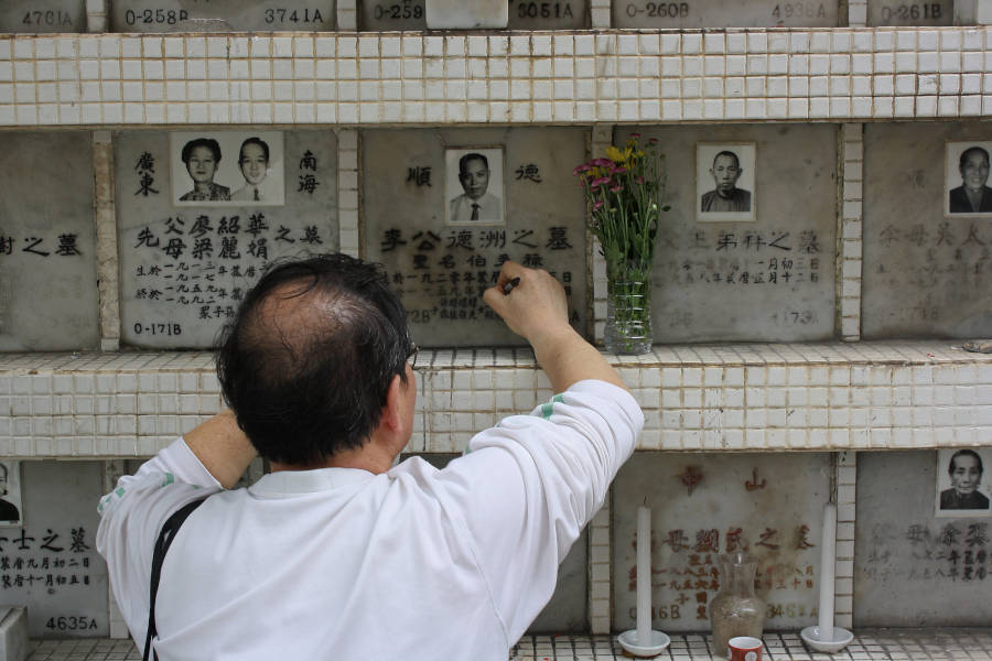 man tending grave of a deceased relative