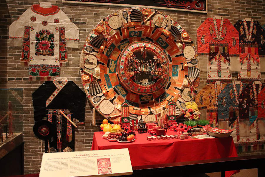 museum display shows paper offerings made during seven sisters festival