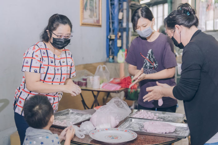 family members making glutinous rice balls together for winter solstice festival