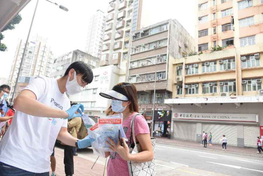 prenetics handing out deep throat specimen covid-19 tests on the street