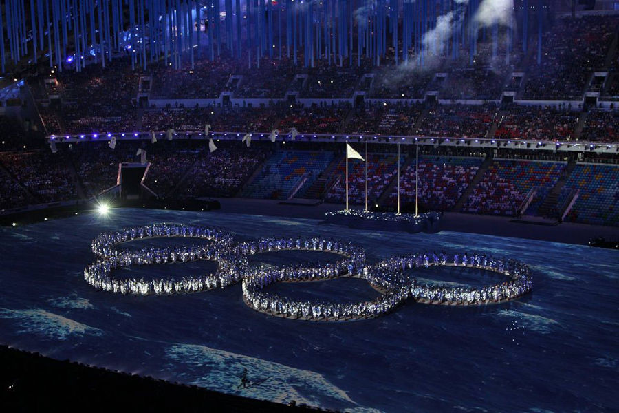 people form olympic rings at winter olympics closing ceremony