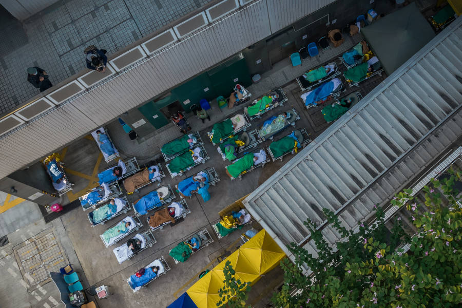 covid patients wait on beds outside hong kong hospital