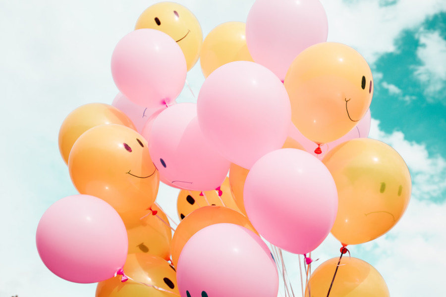 happy face and sad face on balloons