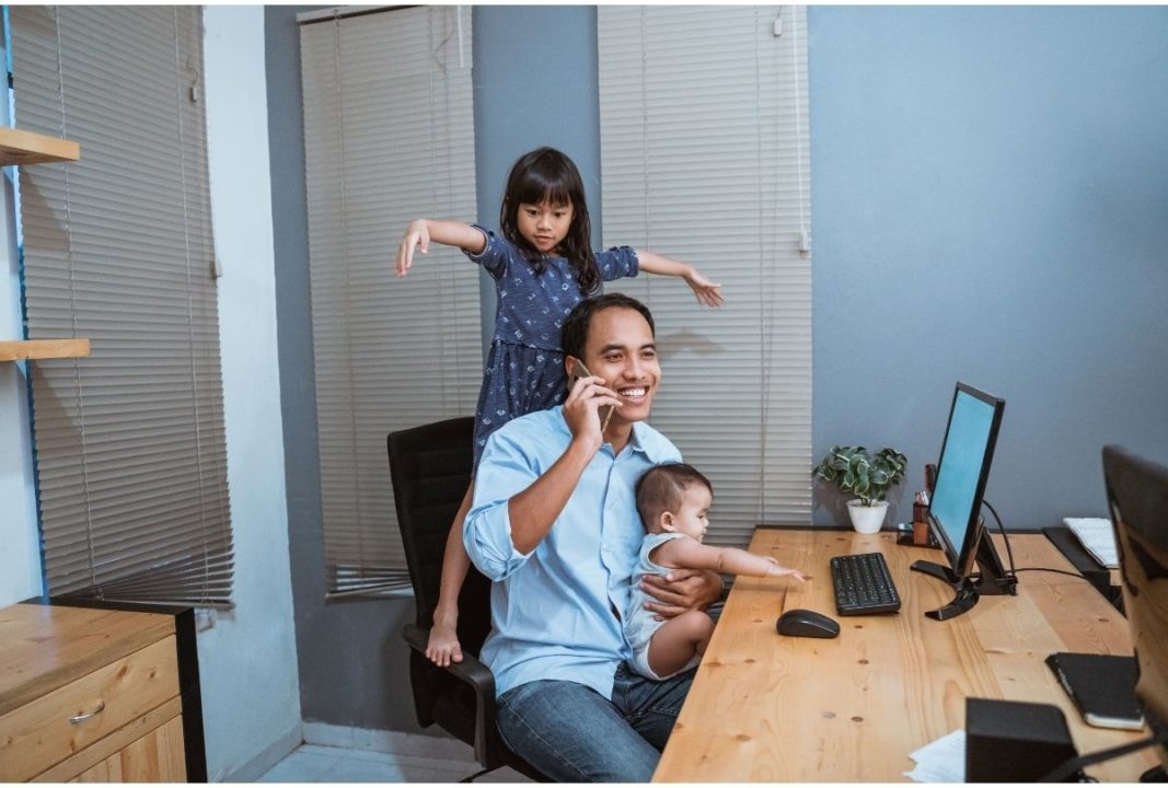dad working from home while taking care of kids