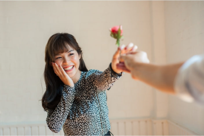 woman receives flower on valentine's day
