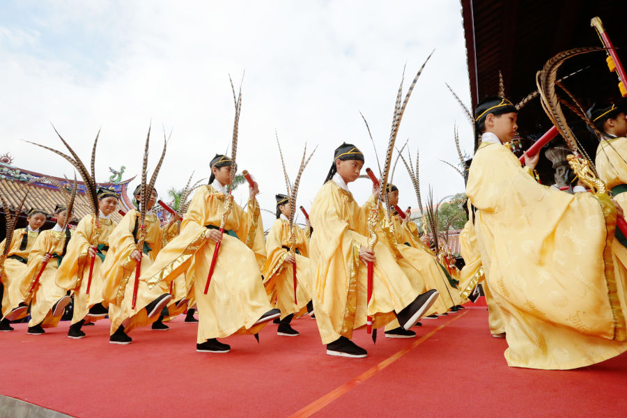 young costumed dancers perform for confucius birthday celebration
