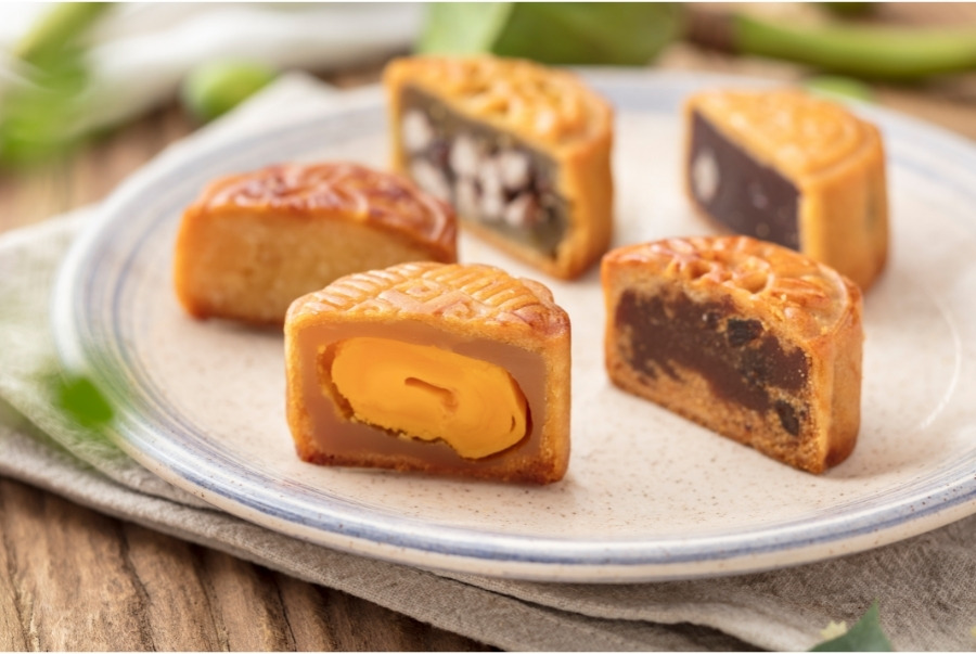 different types of mooncakes cut in half to show fillings