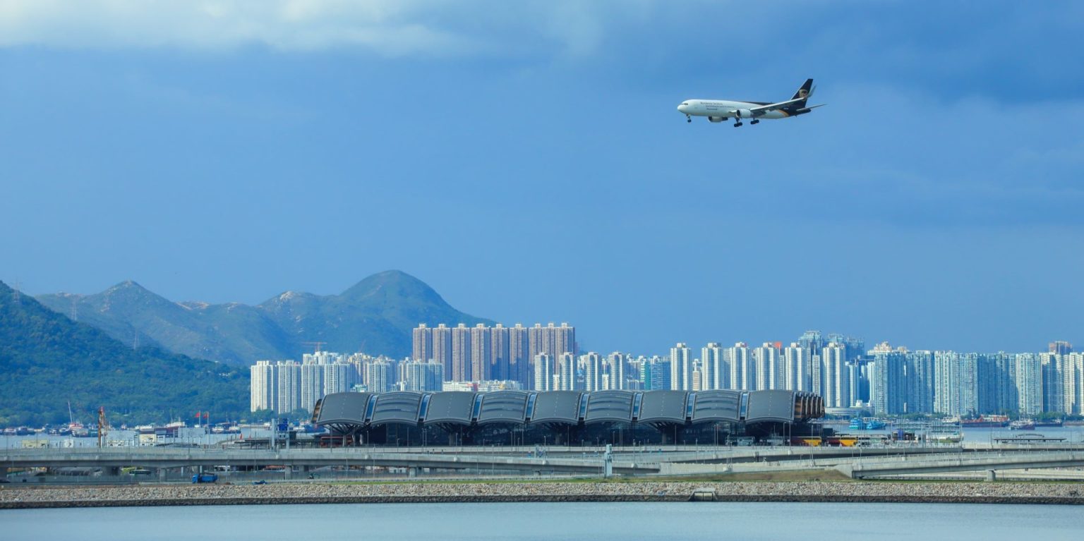 An airplane landing at Hong Kong International Airport