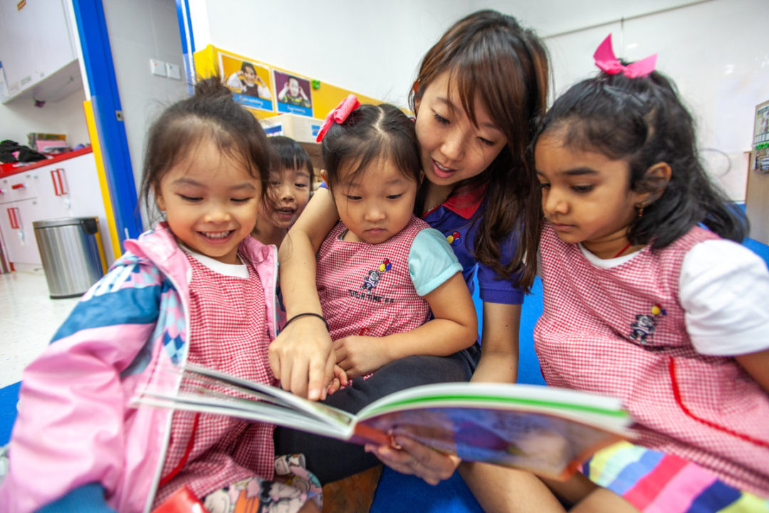tutor time nursery teacher reading storybook to students