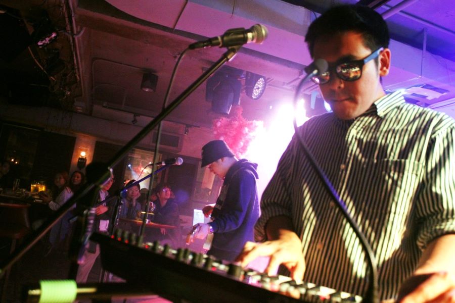 A band plays at Nathan Left in Tsim Sha Tsui. The keyboardist is in the foreground, with the others in the background.