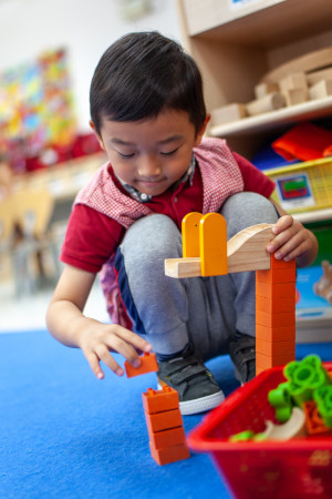 young boy planing with building blocks at tutor time nursery hong kong