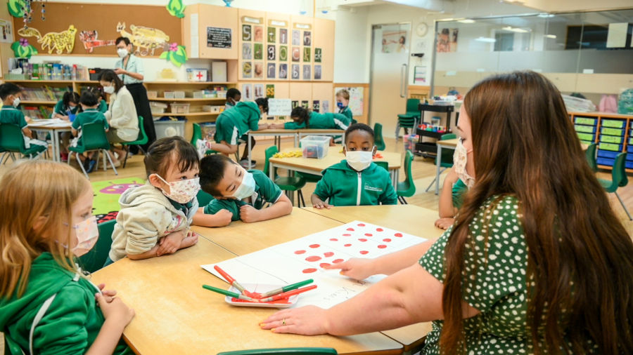 native english teacher reading to students at woodland kindergarten