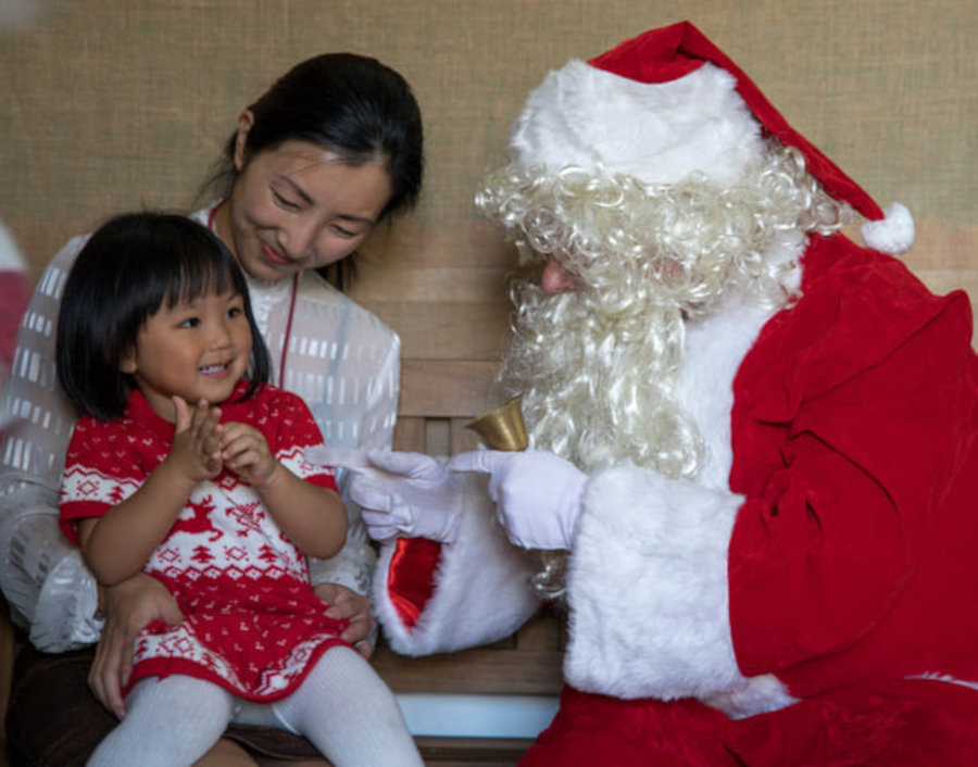 preschool student and mom taking a photograph with santa at city kids hong kong