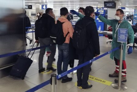 What Are The International Covid-19 Testing Requirements For Passengers Departing Hong Kong? Temperature screening at an airport.