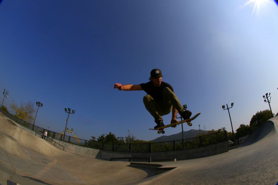 A skateboarder does an air trick.