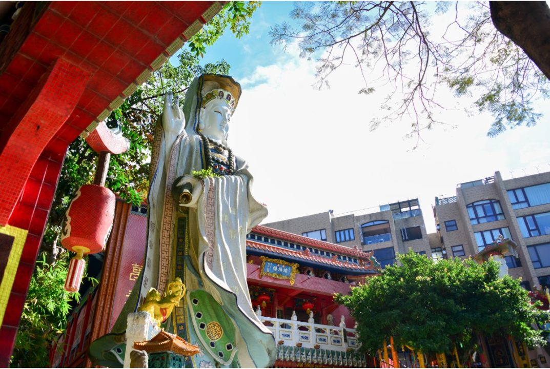 statue of mother goddess guan yin in front of hong kong temple