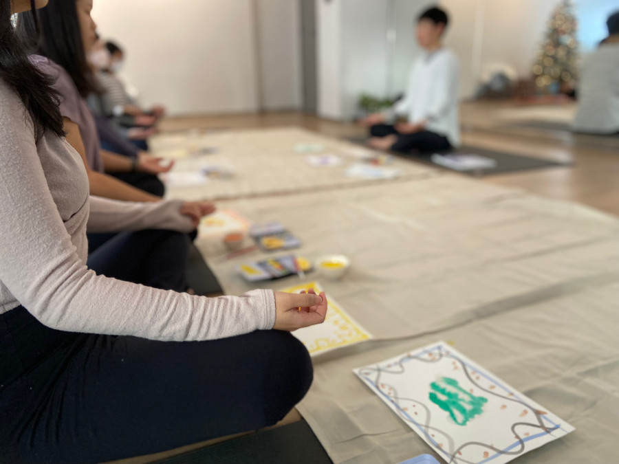 people meditating while painting in a meditation class