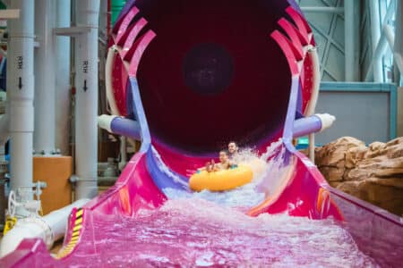 Studio City Indoor Water Park, Macau’s First Indoor Water Park With 16 Attractions Now Open dad and son on water slide in studio city macau indoor water park