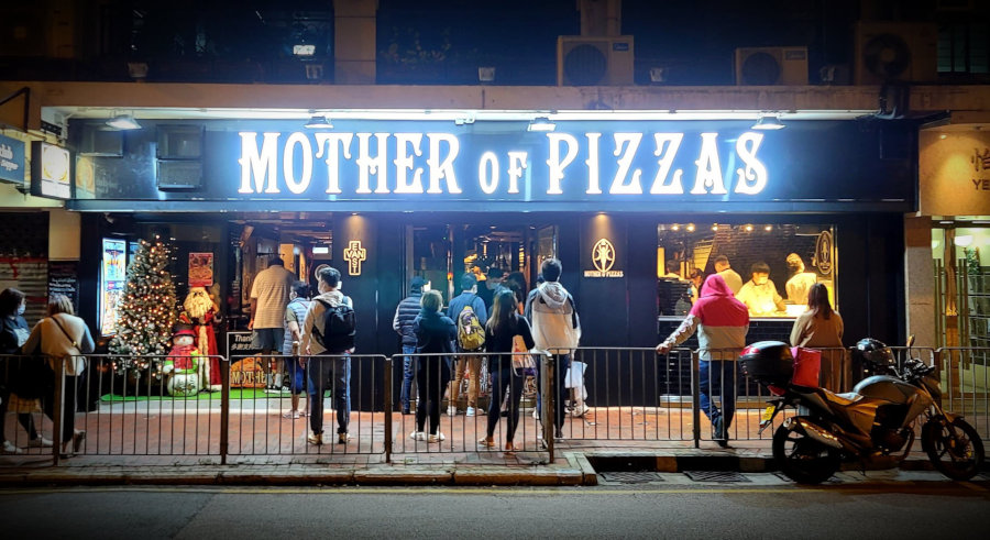 people waiting outside of of mother of pizzas hong kong
