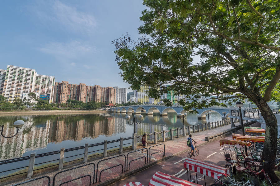 residential buildings and bike path along shing mun river sha tin