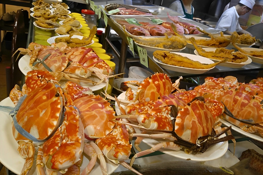 flower crab, deep fried fish displayed on a counter