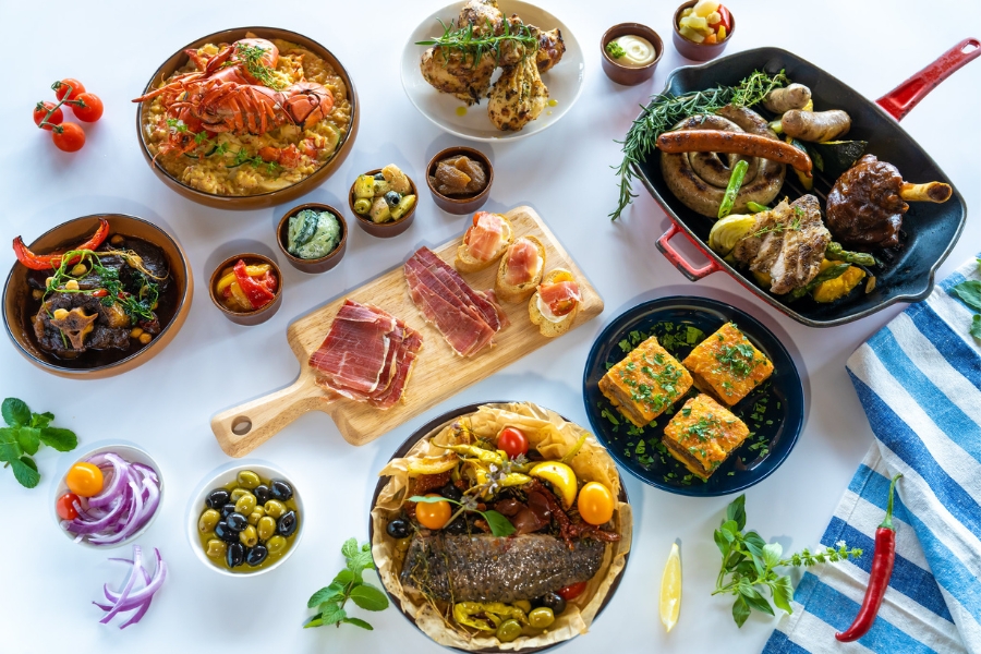 tapas,  paella and iberico ham platter on a table