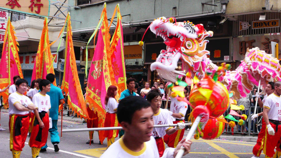 lion dancers at a tin hau festival street parade in yuen long