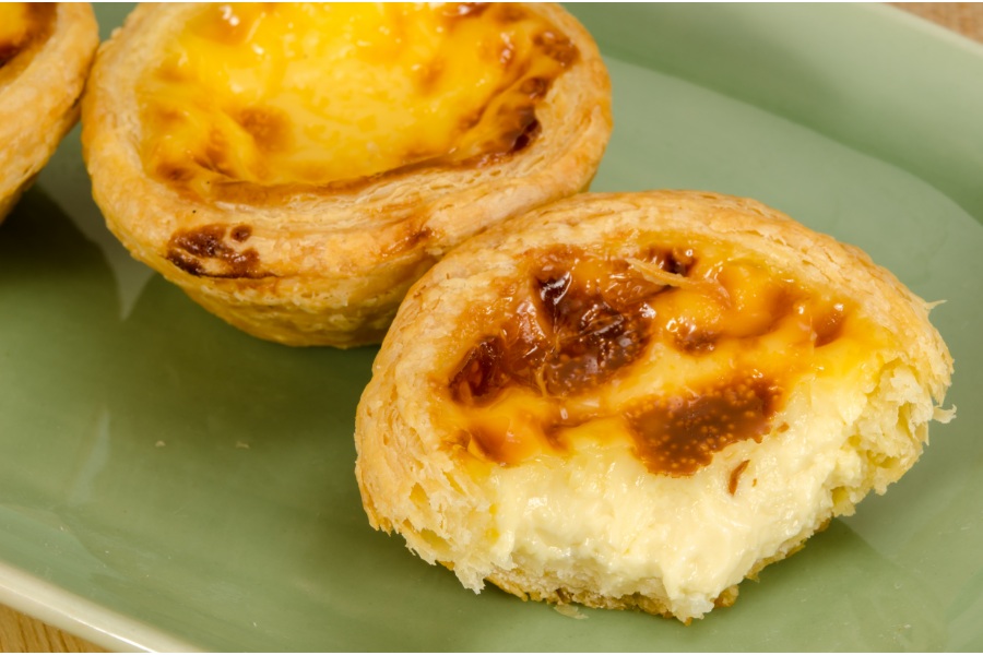 hong kong egg tart with a bite in it