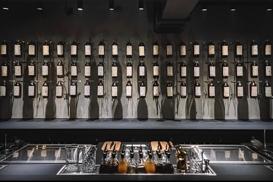 The Penicillin features a wall of bottles of cocktails and ingredients, fixed onto the wall with a laboratory clamping system.