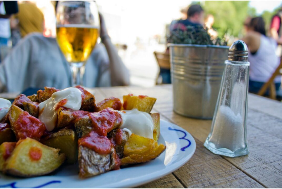 tapas dish of potatoes and beer at tapas bar in barcelona