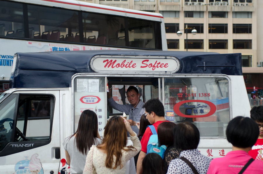 people lining up for soft serve ice cream from mobile softee at tsim sha tsui ferry pier