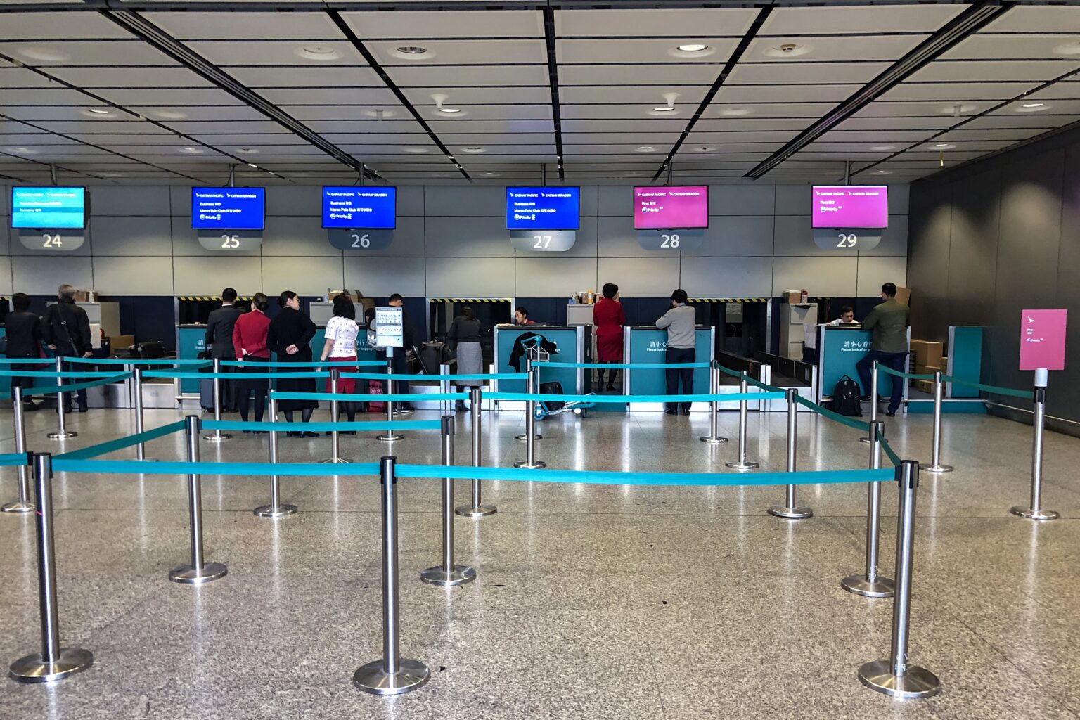 Passengers at the Cathay Pacific check-in counters at the Hong Kong MTR Station