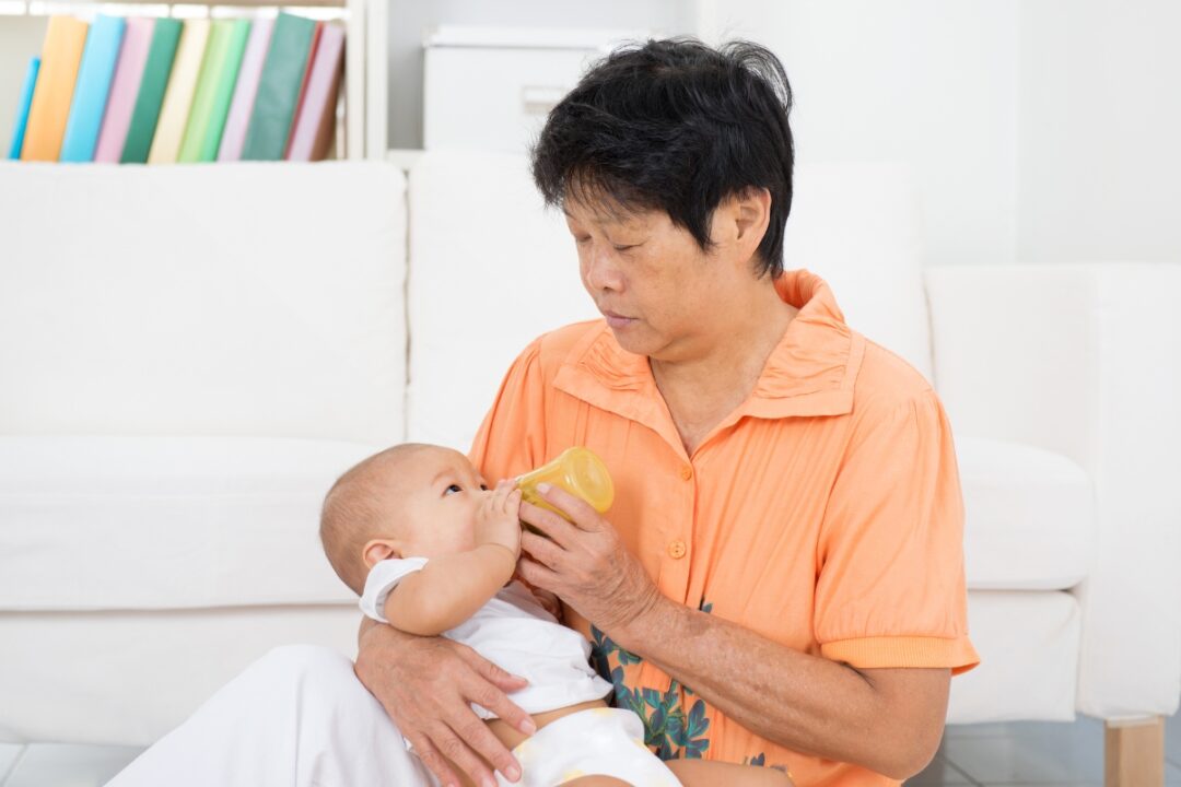 chinese confinement nanny feeding baby