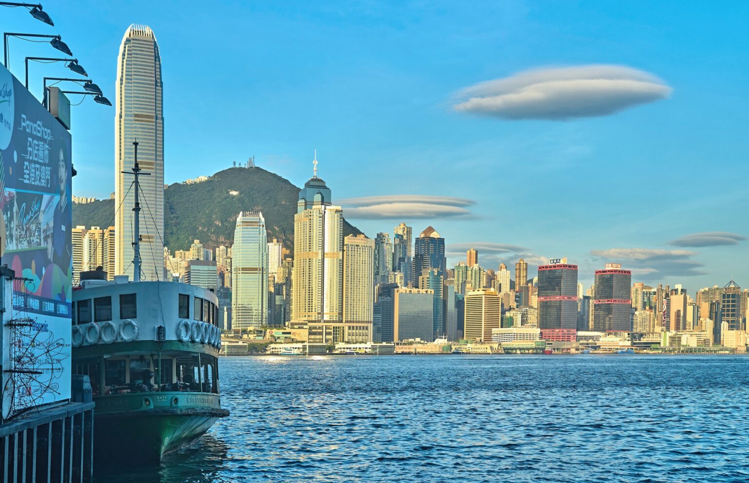 A view of flying saucer clouds seen over Victoria Harbour as seen from the Star Ferry Pier in Tsim Sha Tsui. The skyscrapers on Hong Kong Island can be see in the background.