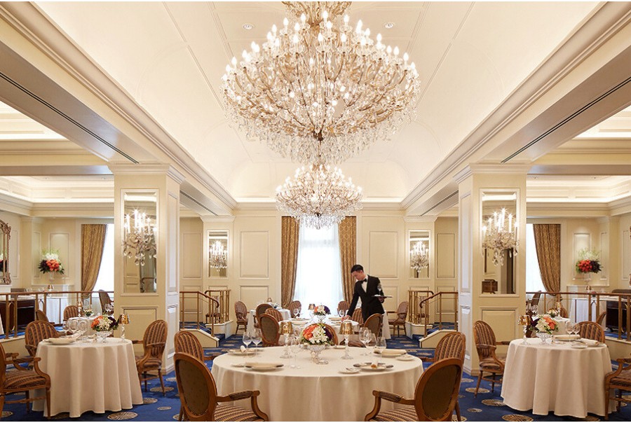 the grand dining room of gaddi's features crystal chandeliers with ornate mirrors