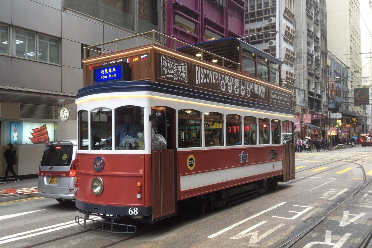Hong Kong's Tram No. 68 on a trip through the CBD. It had a red body with a white trim and wooden accents.