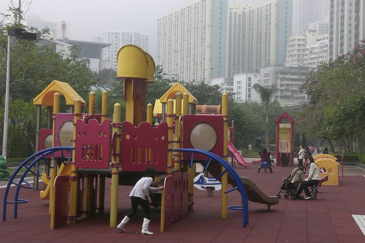 the playground in quarry bay has climbing frames, slides, and colourful play panels