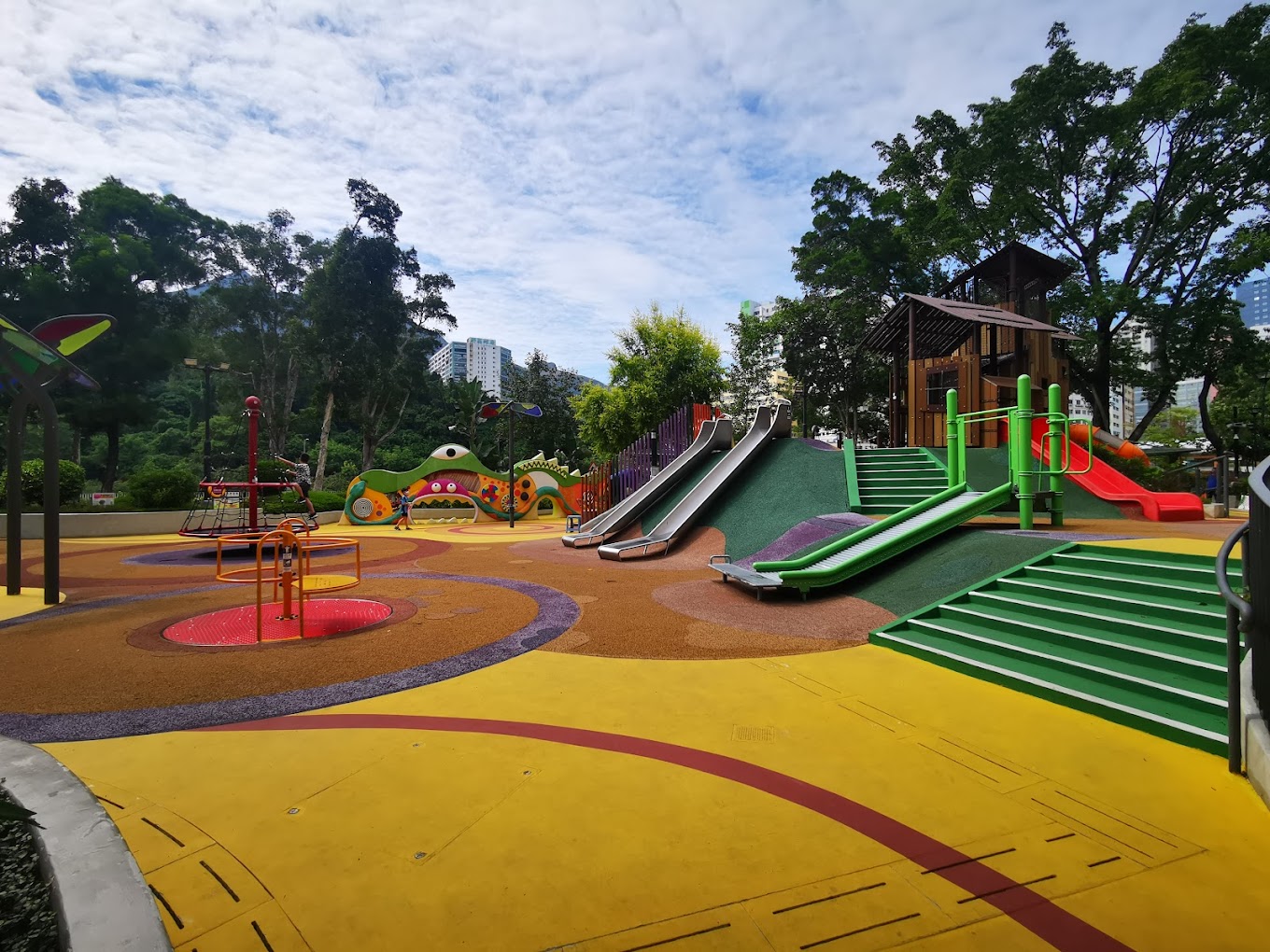 the barrier-free playground at tuen mun park. there ate slides, ramps, spinning equipment, and a rope tower, among other facilities.